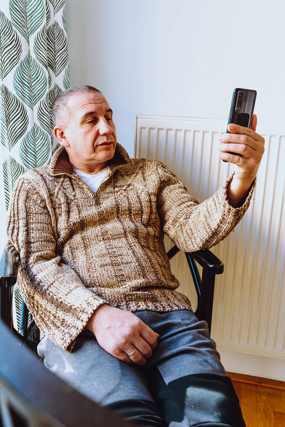 Particulier consultant un site sur son smartphone à la maison