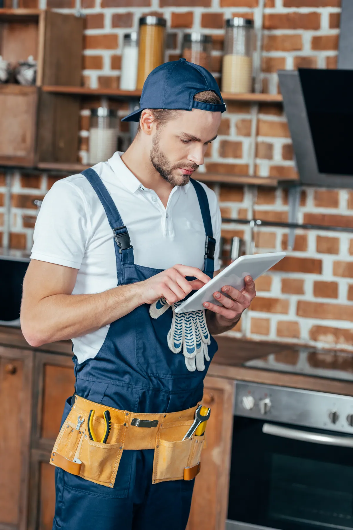 Plombier RGE consultant un outil métier sur tablette en chantier