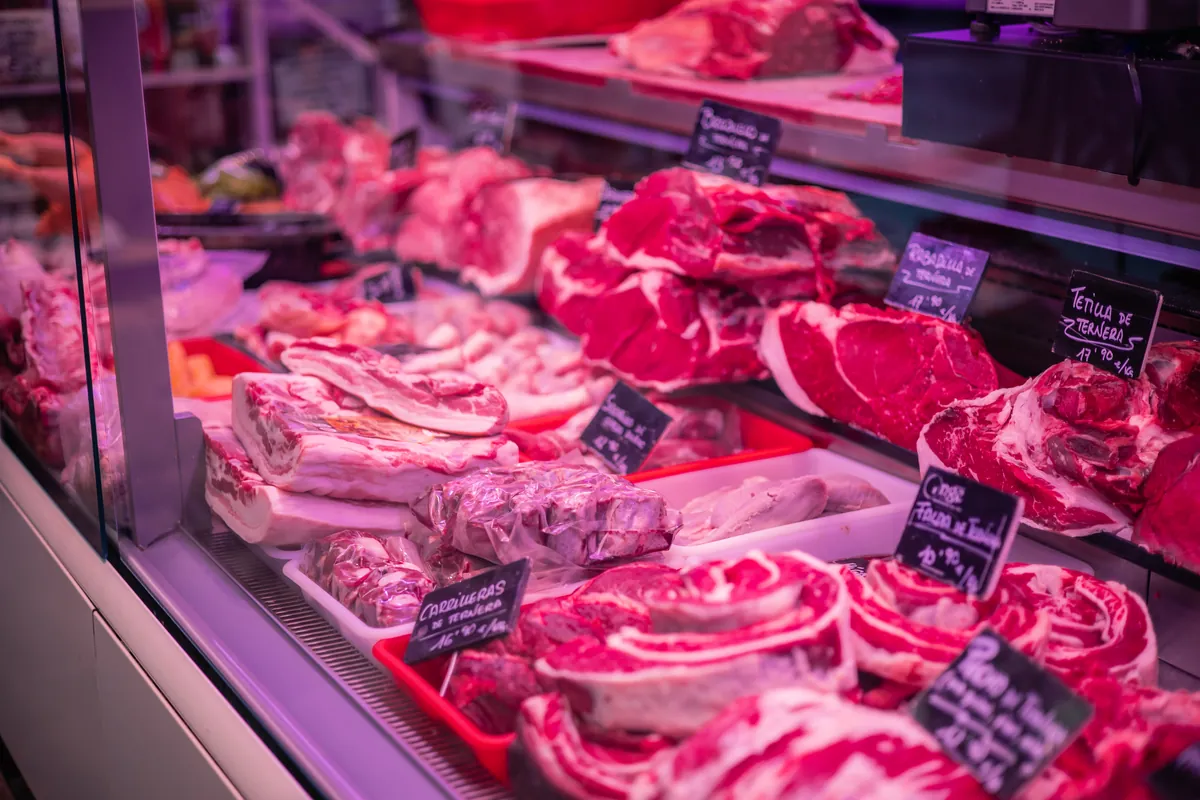Étal de boucher avec viandes de porc, agneau et volaille